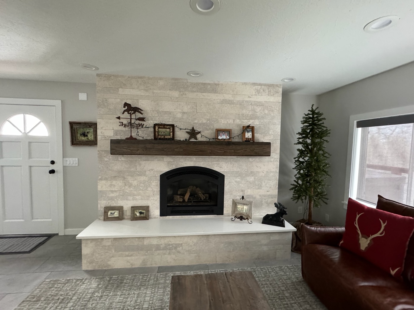 Stone fireplace surround with wood mantel